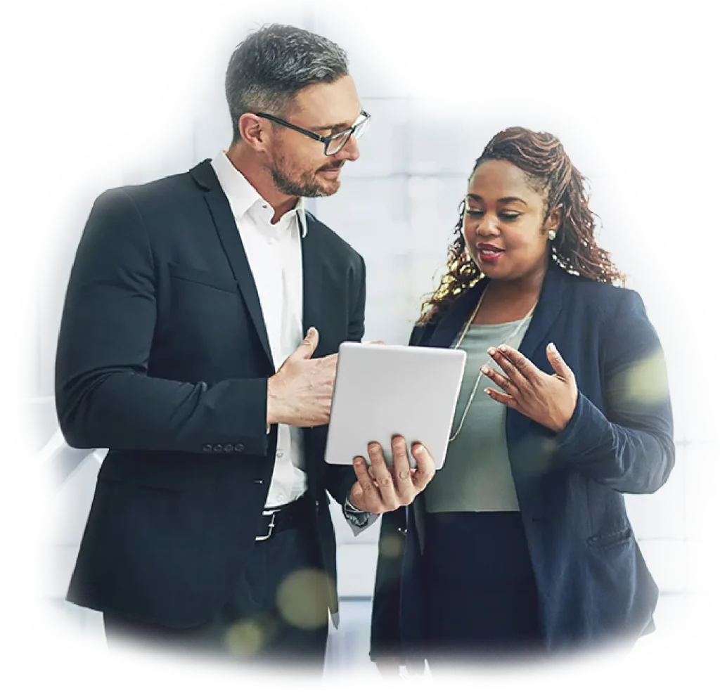 Business man and woman standing looking at iPad